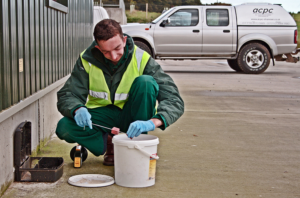 ACPC Technician servicing a perimiter bait box.